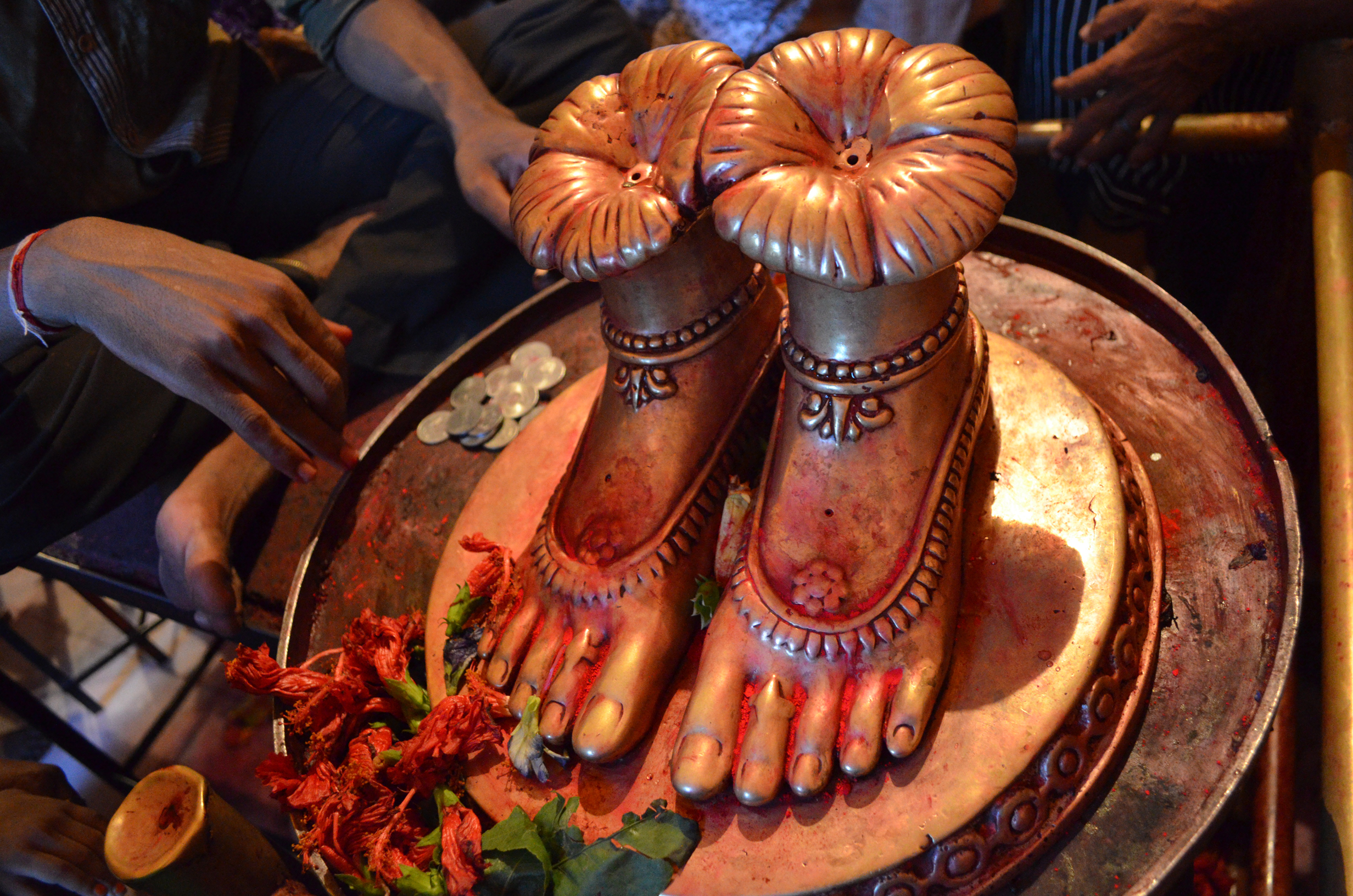 Tara Ma's feet receiving offerings at Tarapith